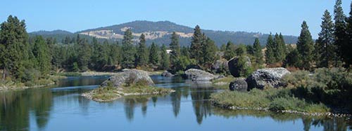 scenic view of the Spokane River with mountain