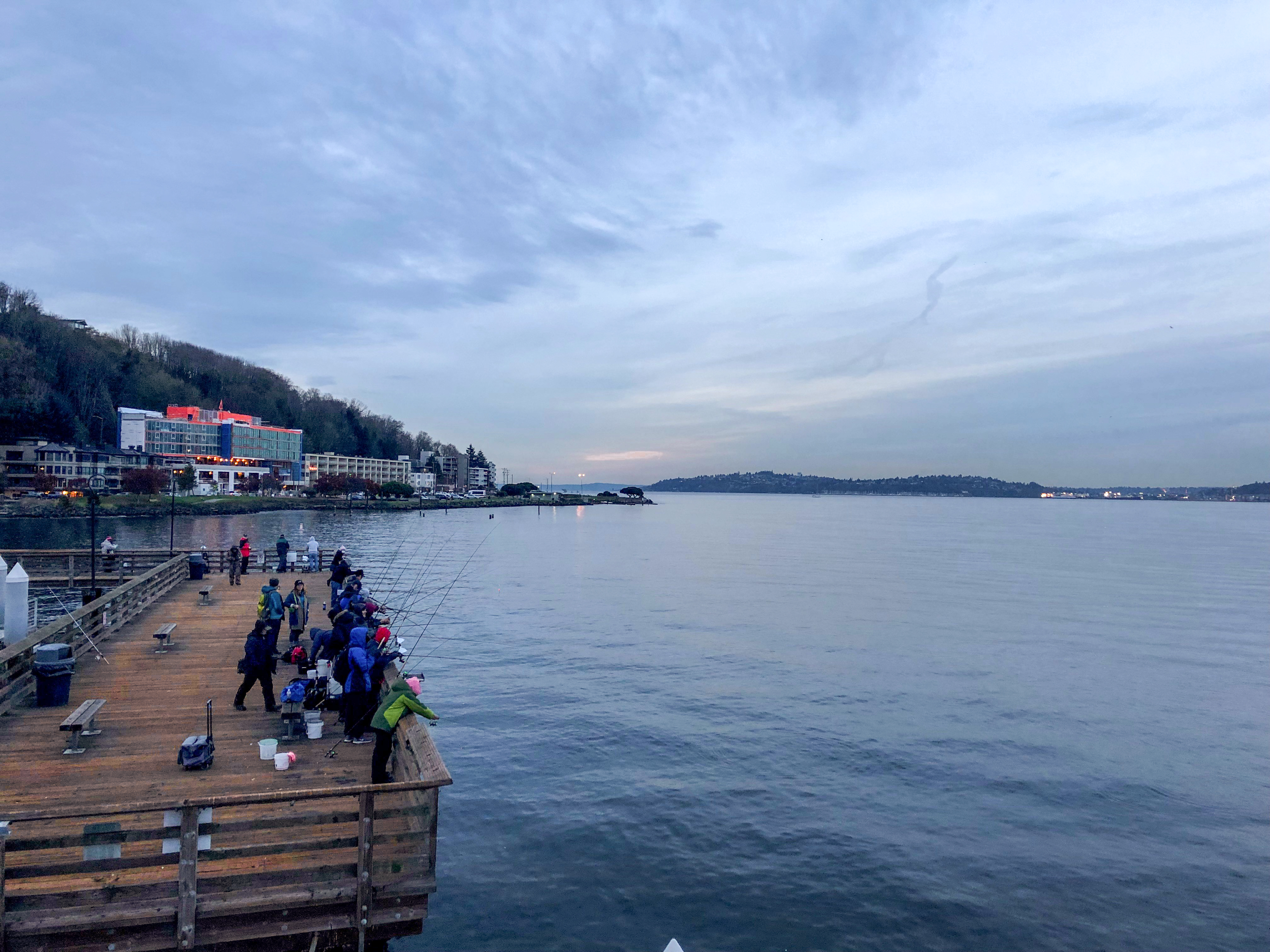 people fishing off the end of a wooden patio